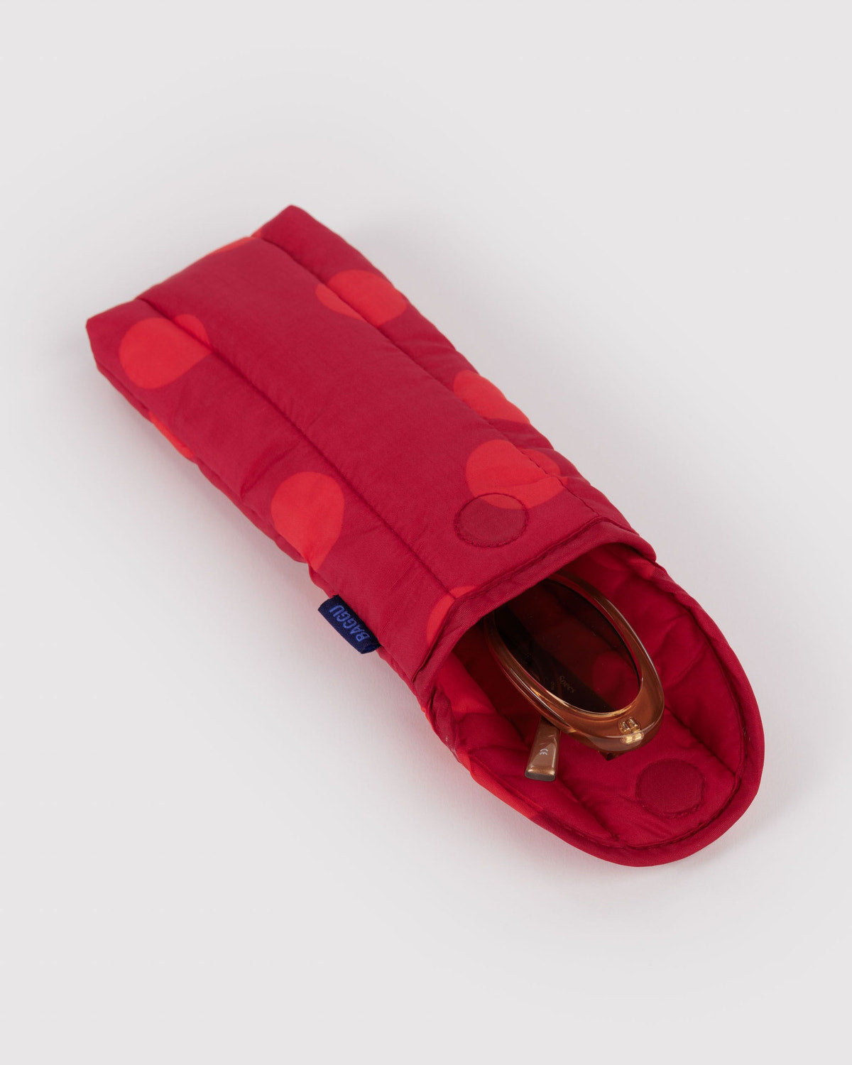 Puffy glasses sleeve in red with dot pattern, padded cover, and glasses pouch opening