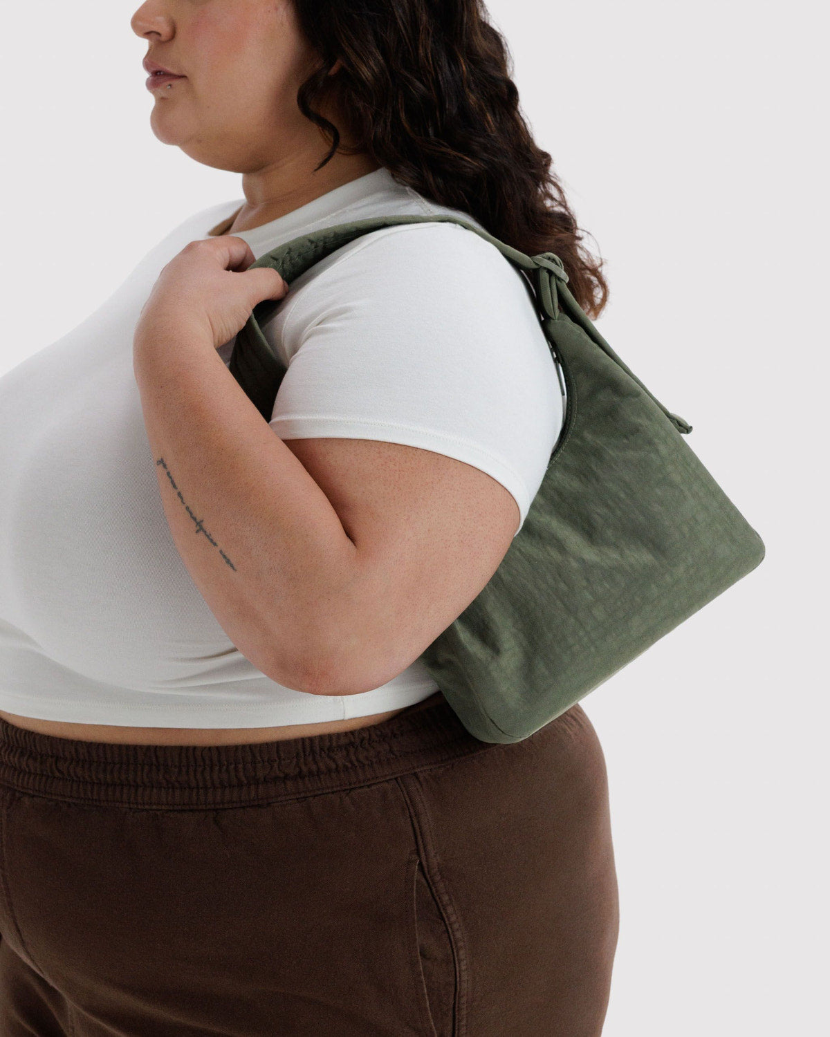 Mini nylon shoulder bag in dark green, curved hobo shape with short top handle