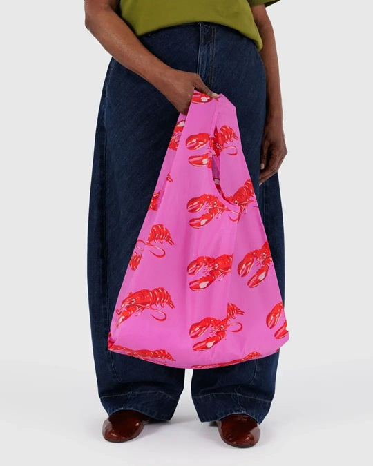 Reusable tote bag with red lobster print on bright pink fabric