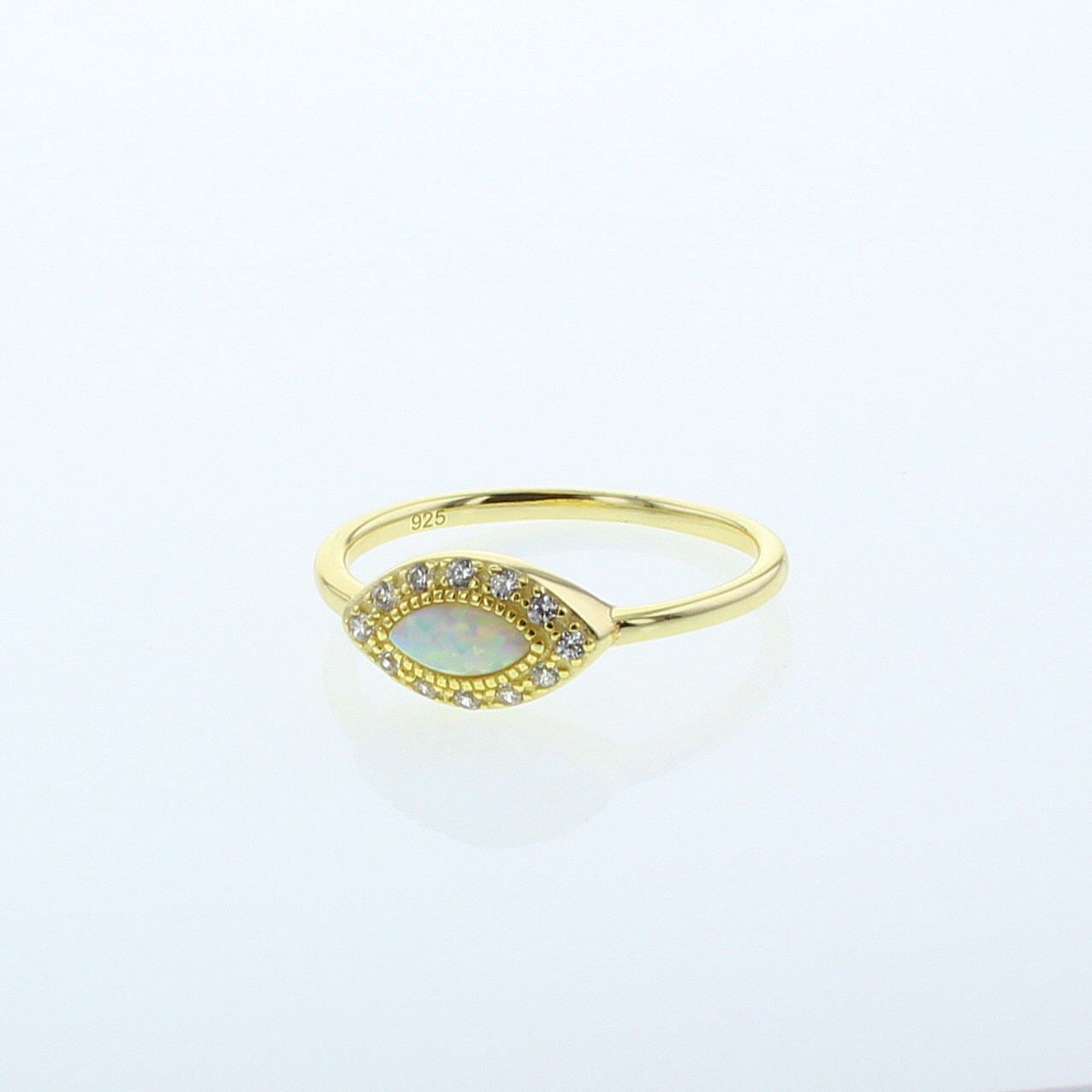 Genesis gold ring with marquise opal center and small clear stones