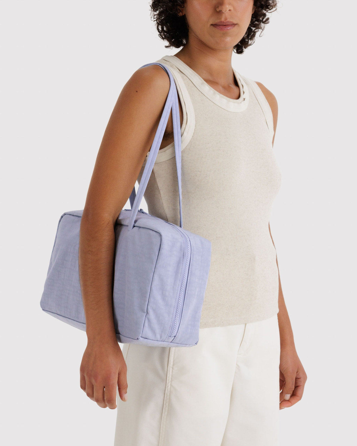 Lavender nylon bowler bag worn by model, top zip and short handles