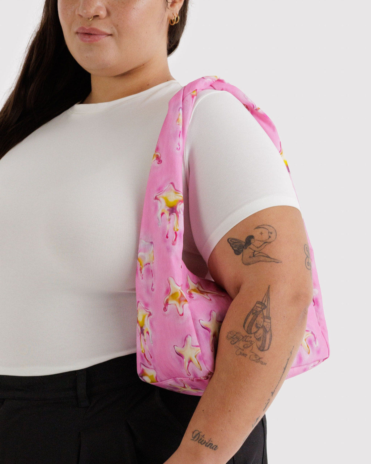 Pink starfish meringue bag on shoulder with short handle