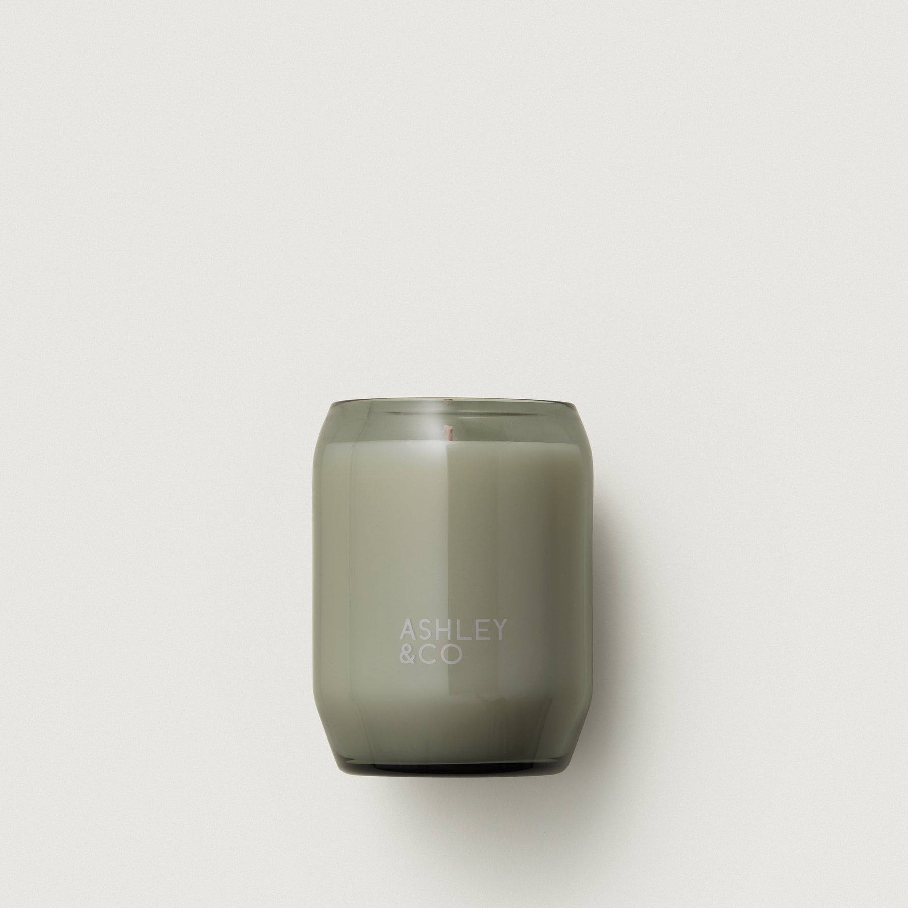Smoky olive waxed perfume candle in a frosted glass jar