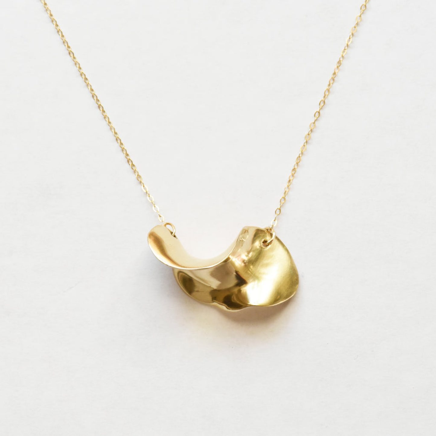 Gold wave brass pendant necklace with small loop clasp