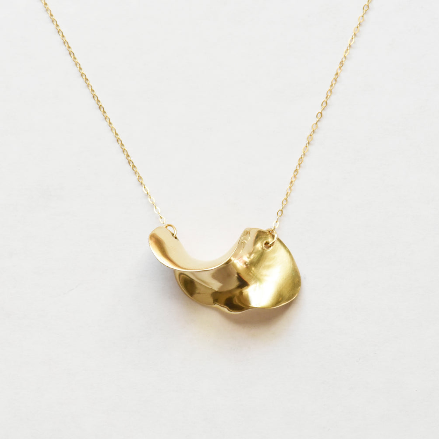 Gold wave brass pendant necklace with small loop clasp