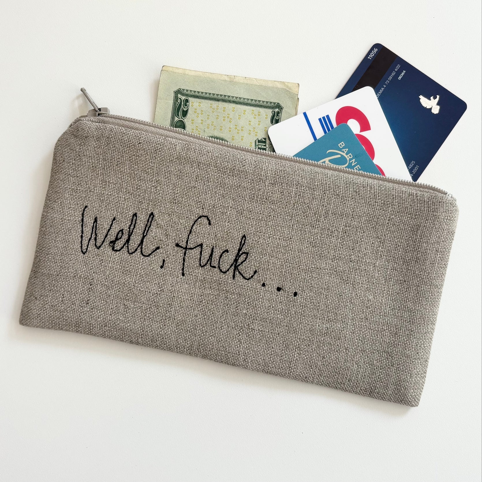 Gray linen zip pouch, 'Well, Fuck...' print, holding cards and cash