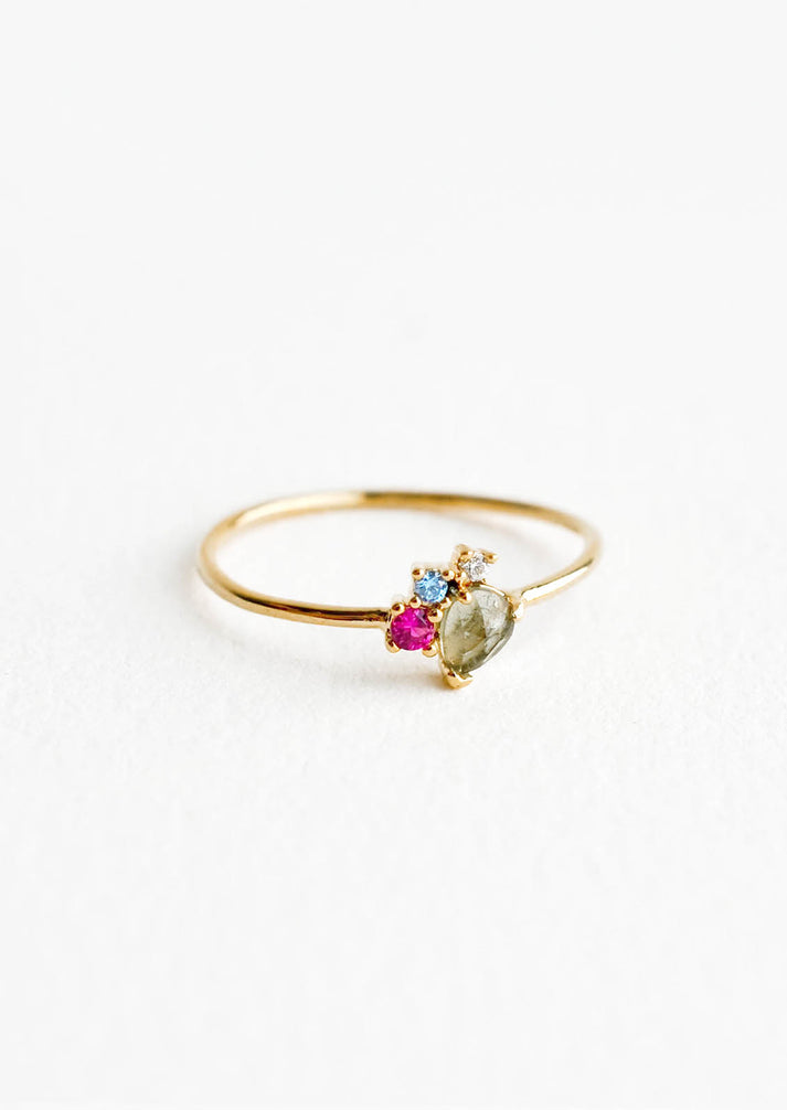 Gold cluster stone ring with oval green center stone and small blue and purple accents
