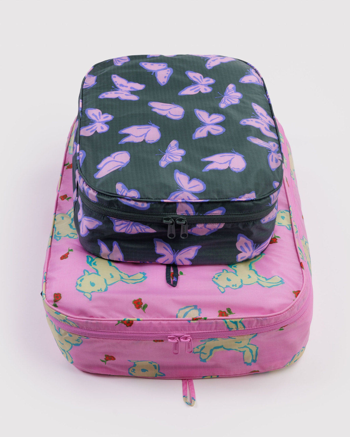 Large packing cube set with dark purple butterfly print and pink top, zipped