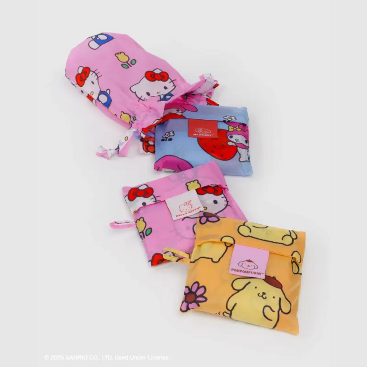 Three character-print drawstring pouches in pink, blue, and orange