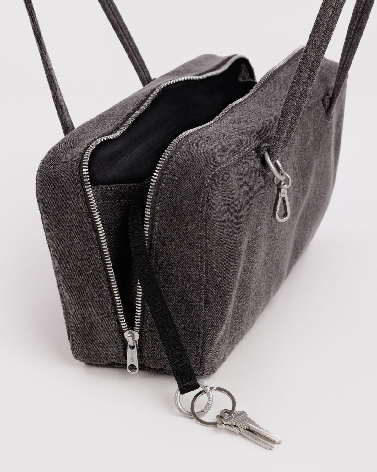 Gray-black denim bowler bag close-up of zipper, interior pocket, and key ring