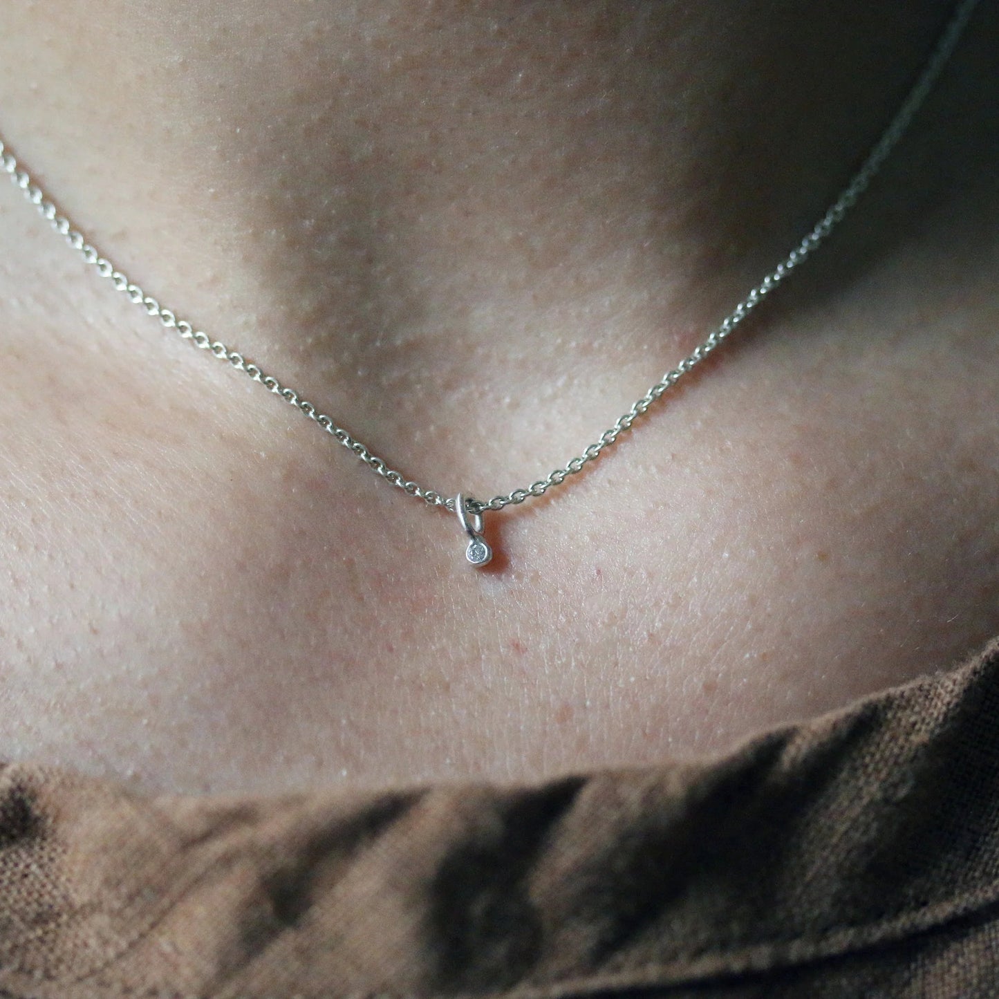 Sterling silver diamond-fleck necklace with small teardrop pendant