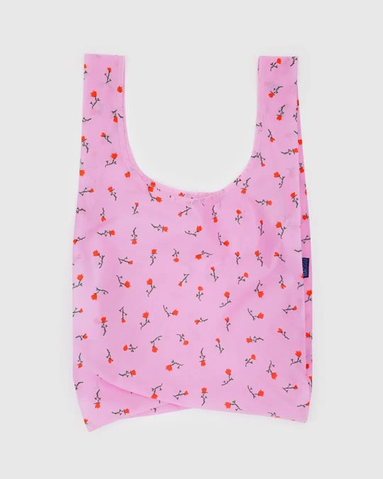 Reusable tote bag in light pink with small bird print and short U-shaped handles.
