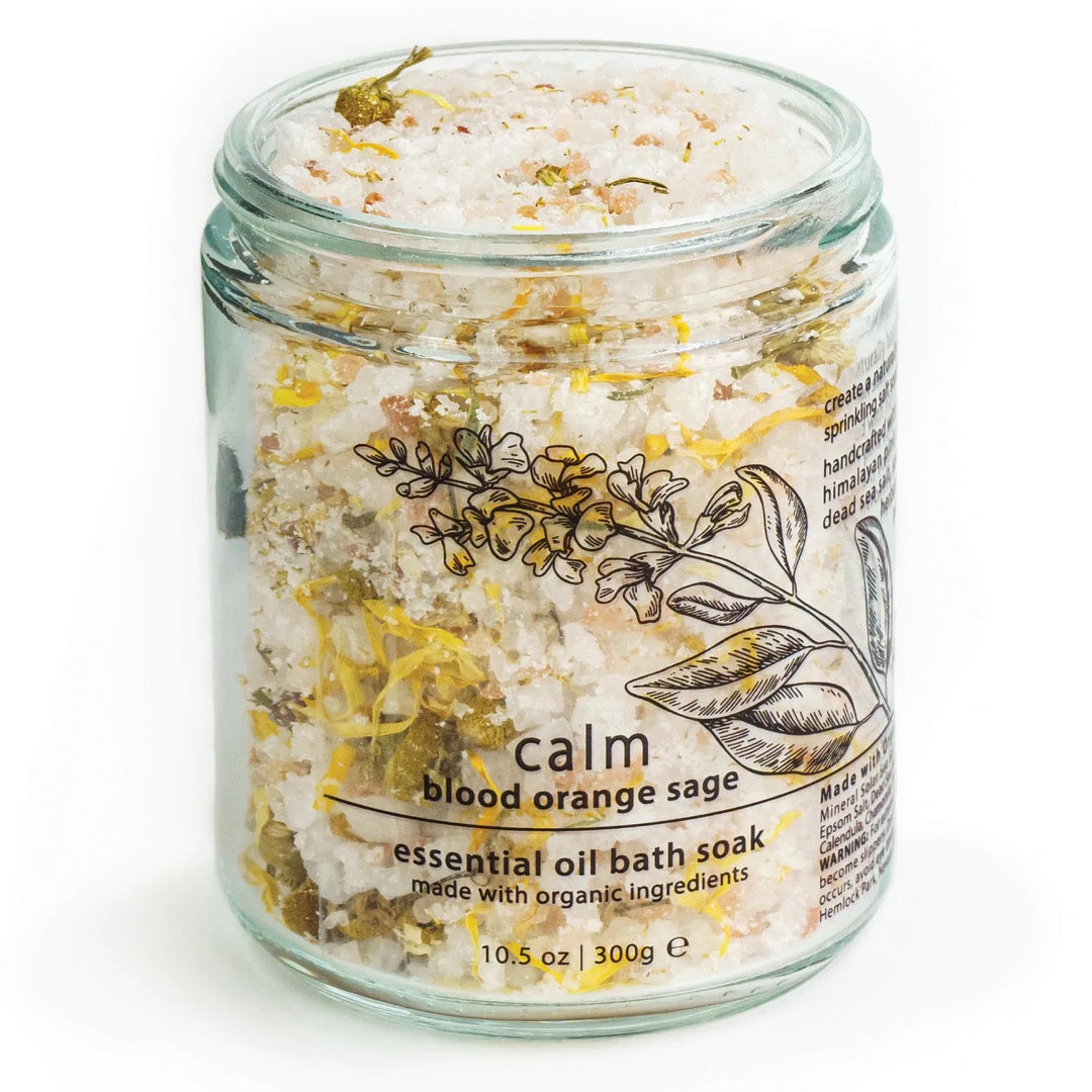 Essential oil bath soak jar with yellow bath flakes and botanical label