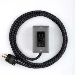 Exto USBC dual outlet cord with black braided cable and black dual outlet on gray plate