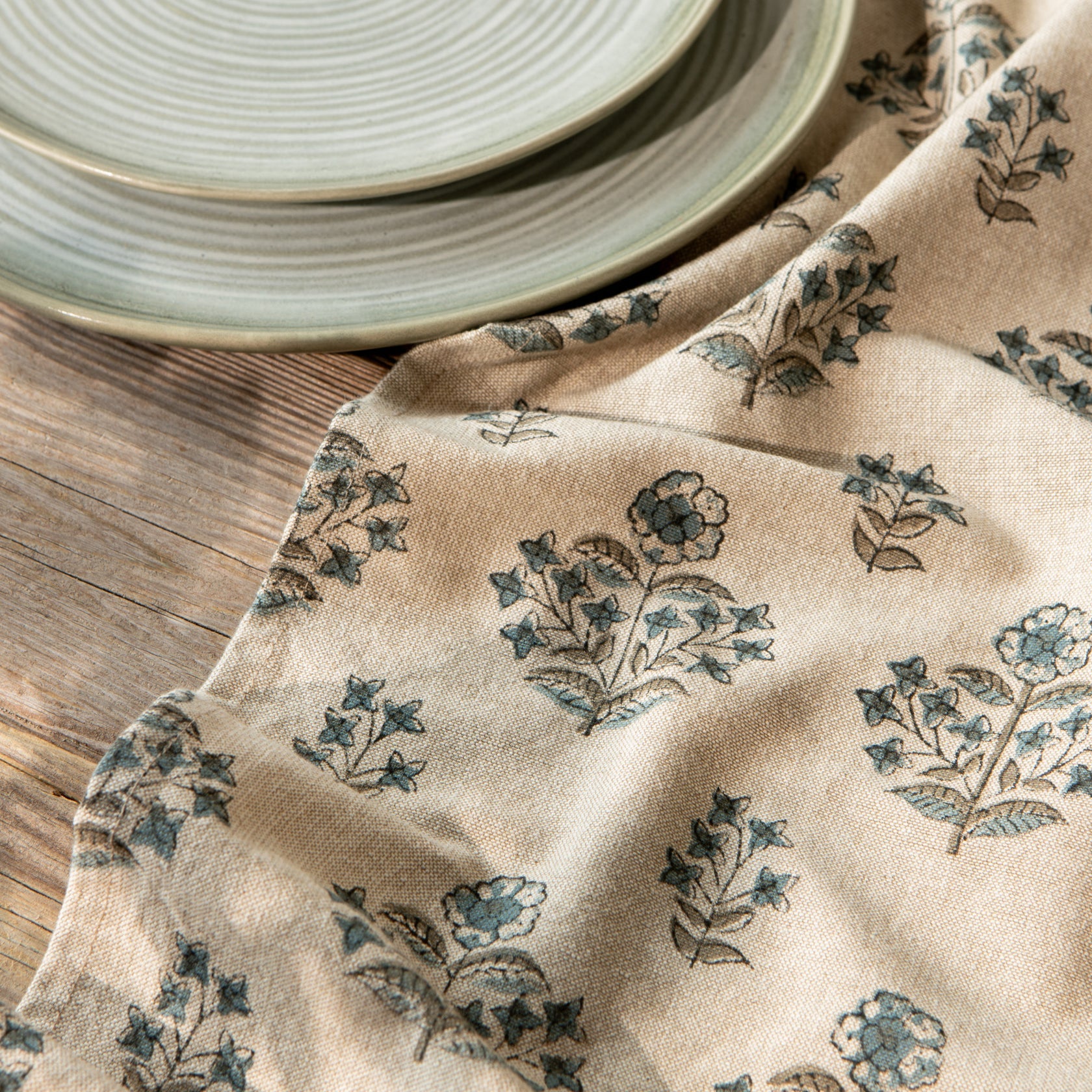 Beige dishtowel with teal botanical block print detail