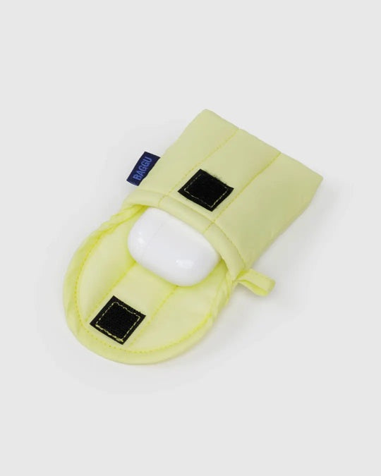 Pale yellow puffy earbuds case with black square patches and quilted flap, earbuds inside