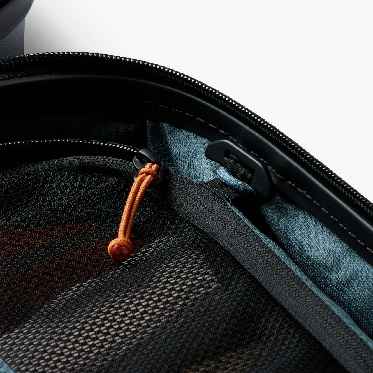 Black carry-on suitcase zipper with fabric trim and orange plus blue pull cords