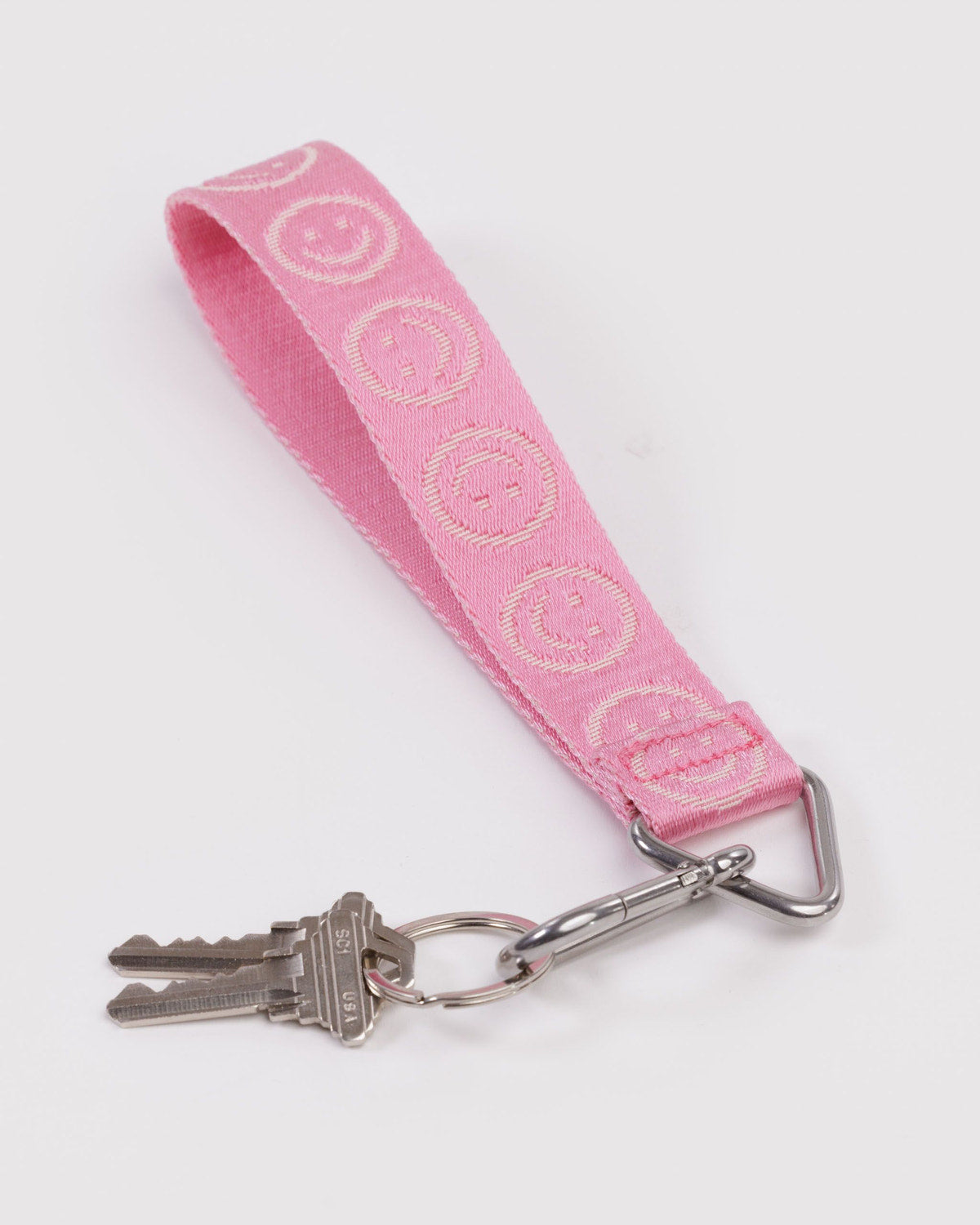 Pink logo fabric keychain with key ring, swivel clip, and two metal keys attached