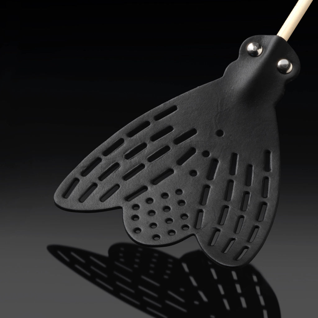Essey fly swatter head close-up with black perforations, vented slots, metal rivets