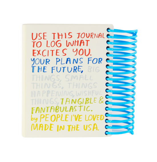 Journal interior page with blue spiral binding and colorful log-excitement text