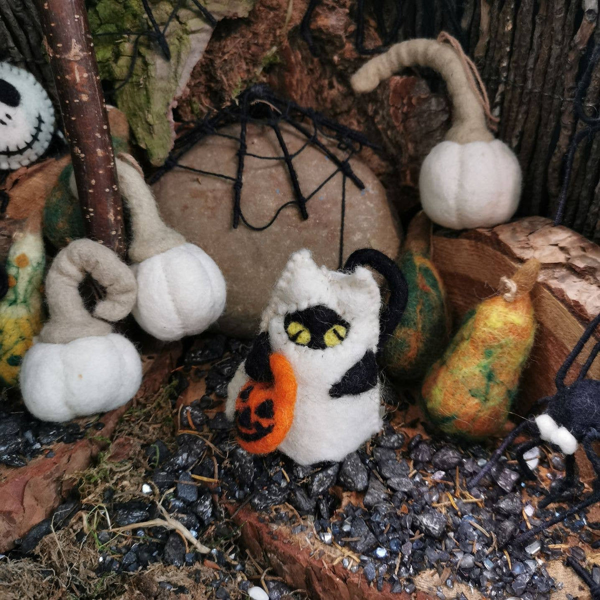 Felt cat hanging decoration with yellow pumpkin and black-and-white ghost details