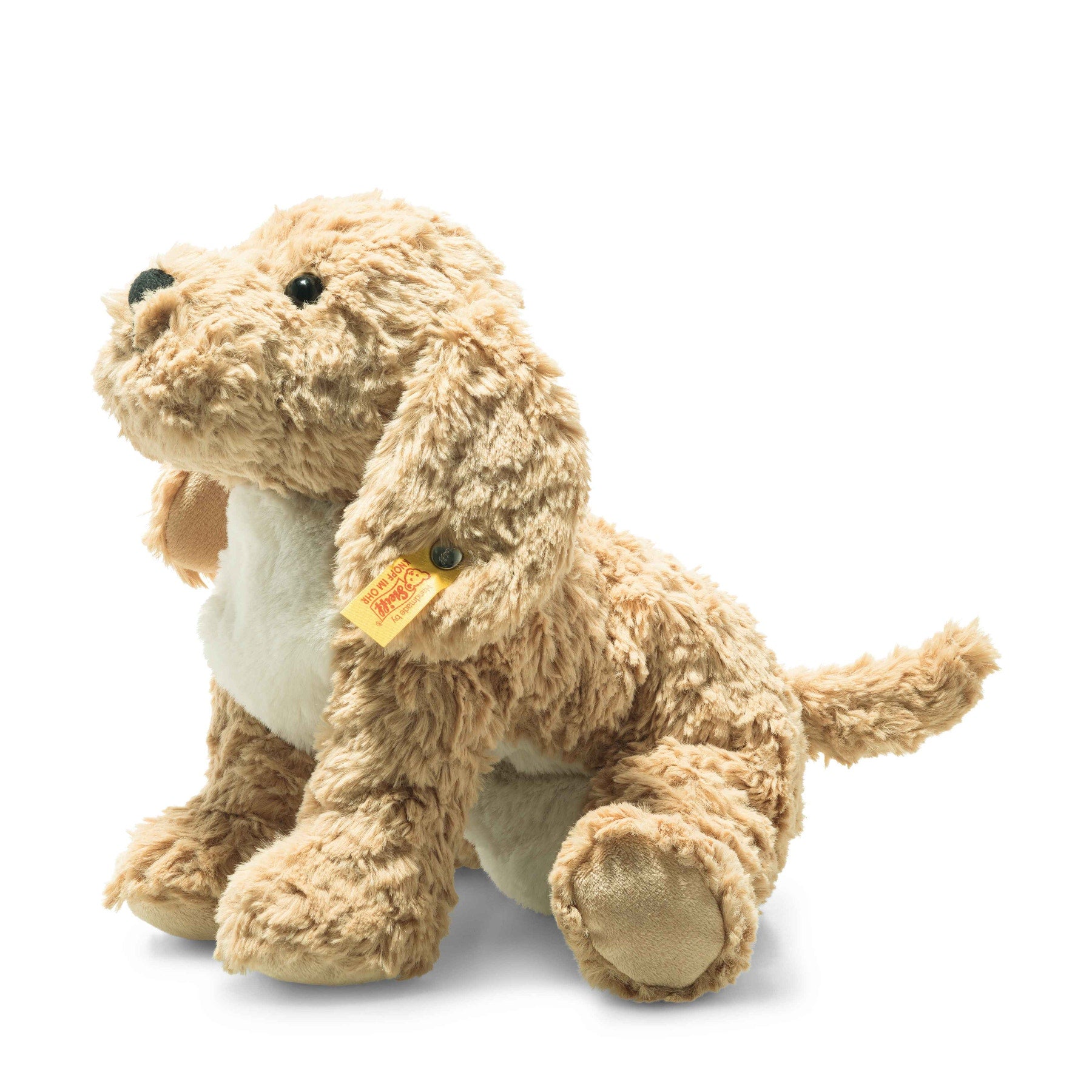 Goldendoodle puppy plush with tan curly fur, light belly, and orange tag