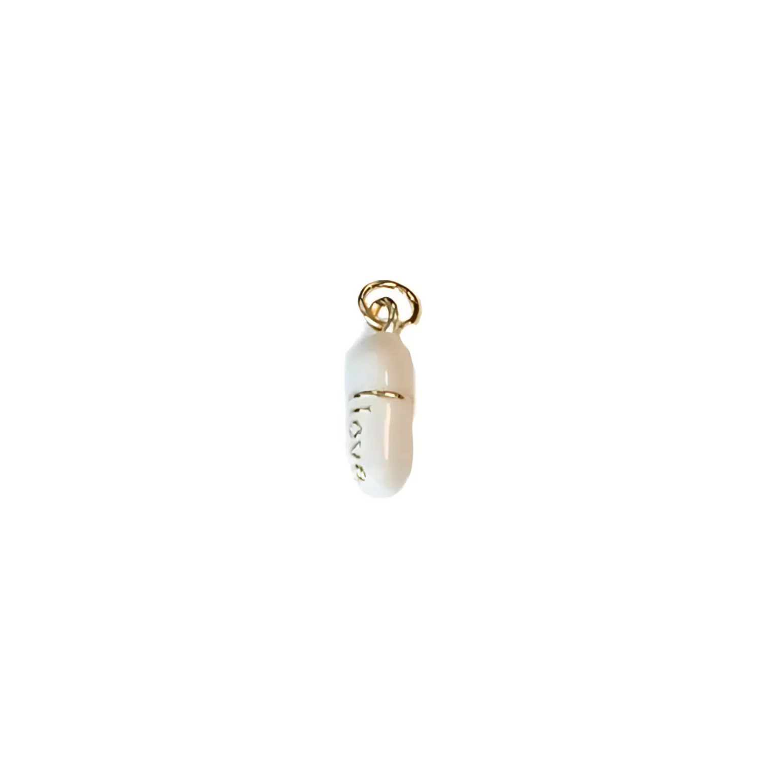 Gold-tone pill charm with white bead, love engraving, and ring bail top