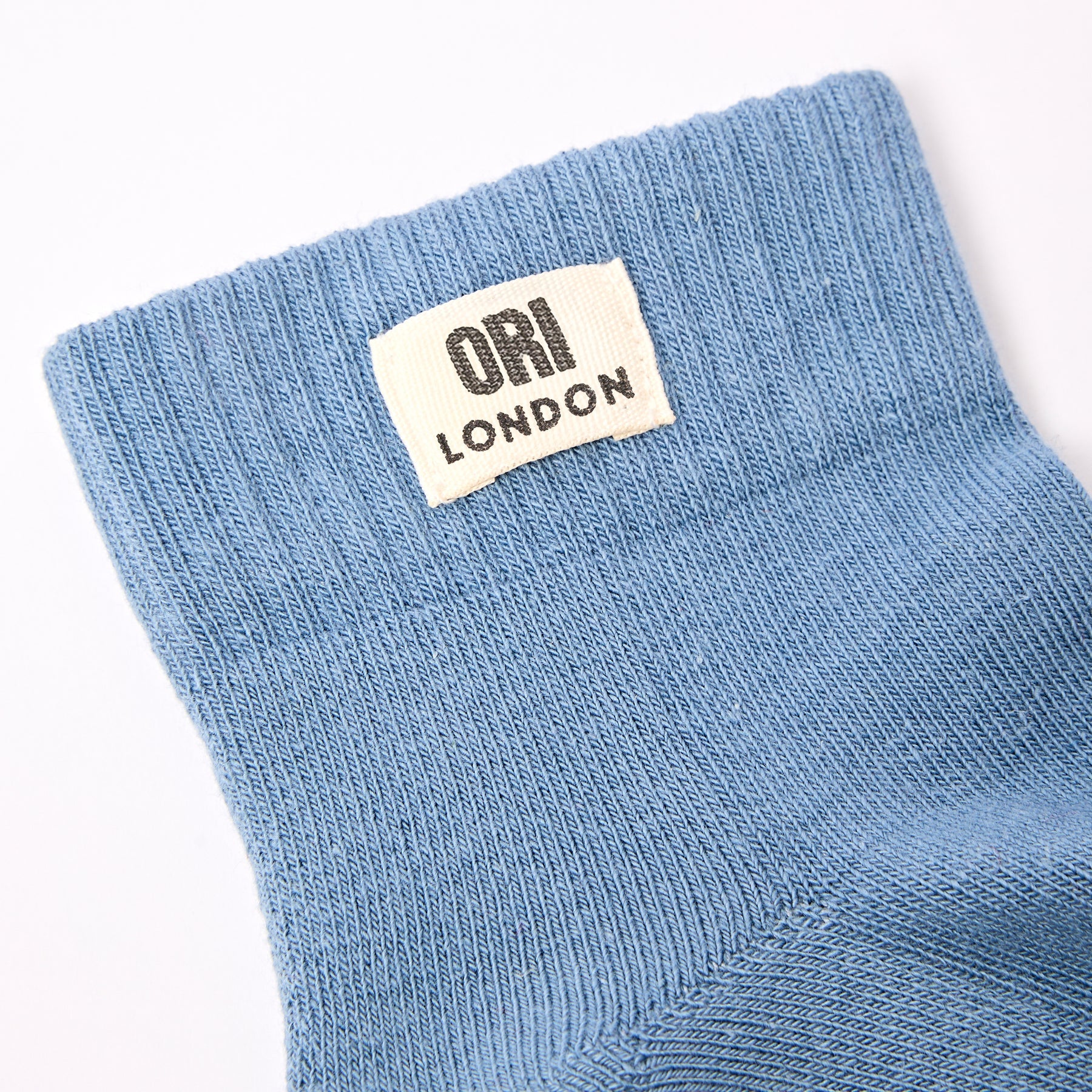 Men's airforce blue ankle socks with ORI LONDON logo patch at the cuff.
