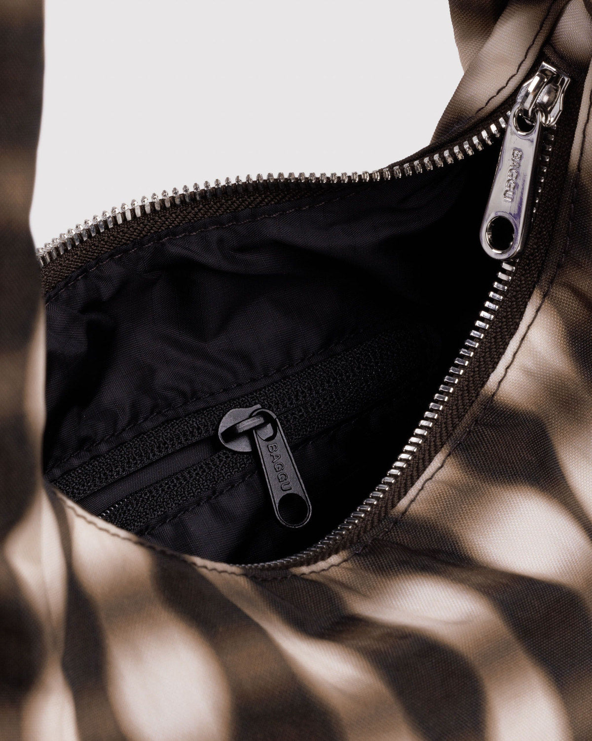 Small nylon meringue bag interior view with zipper and pocket tab