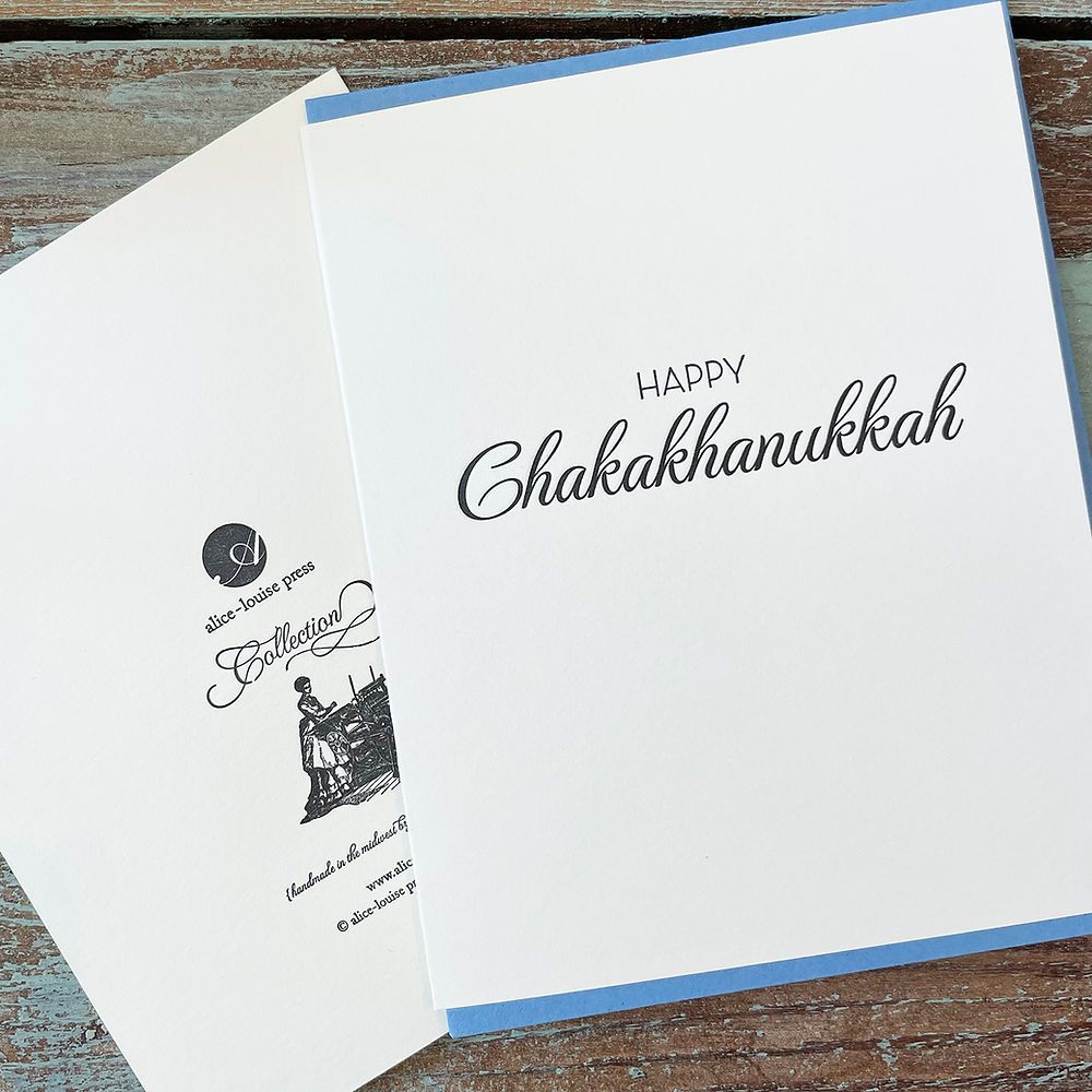 White greeting card with 'HAPPY' and 'ChakaKhanukkah' script text on front