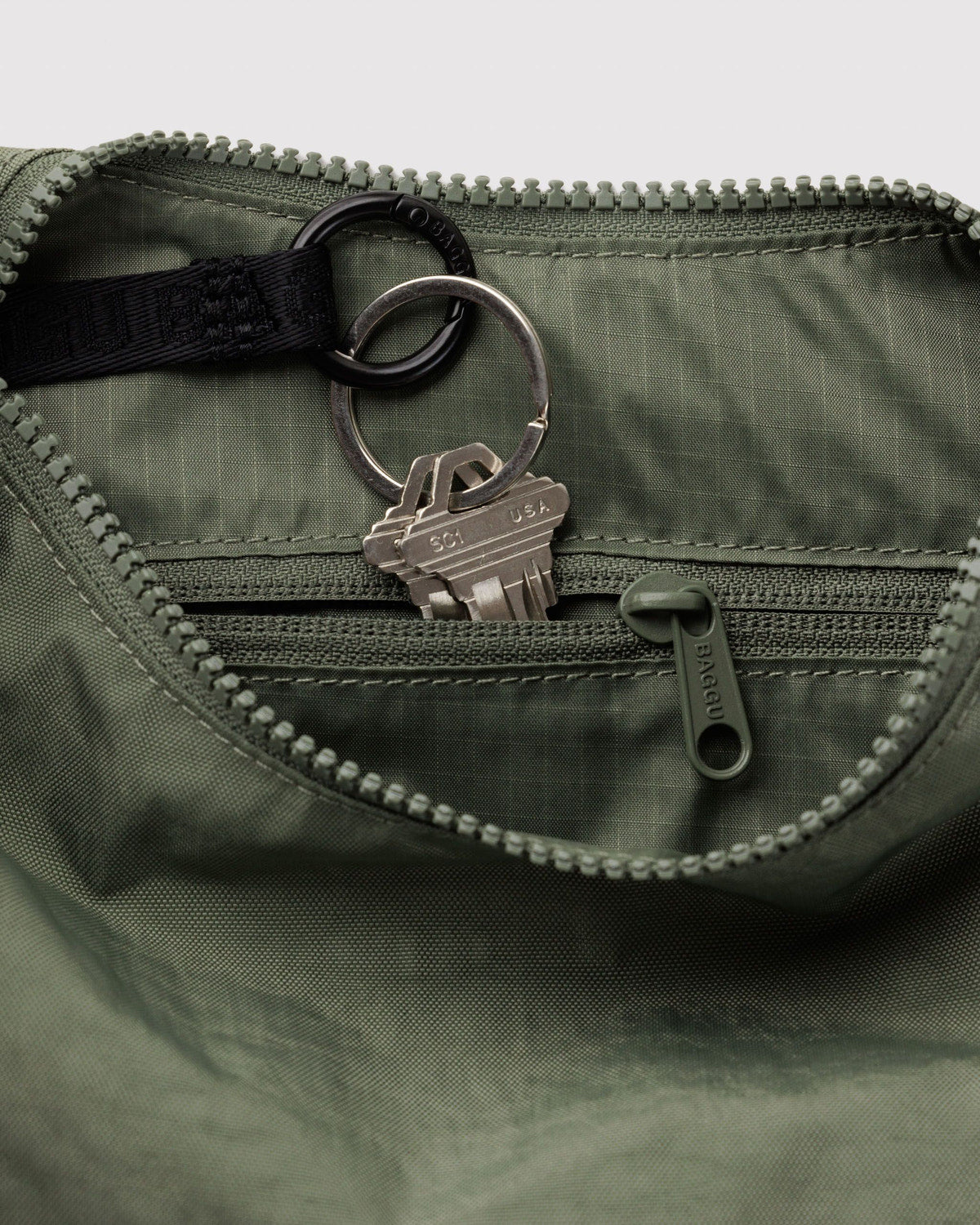 Small nylon crescent bag, olive green interior with key clip and zipper