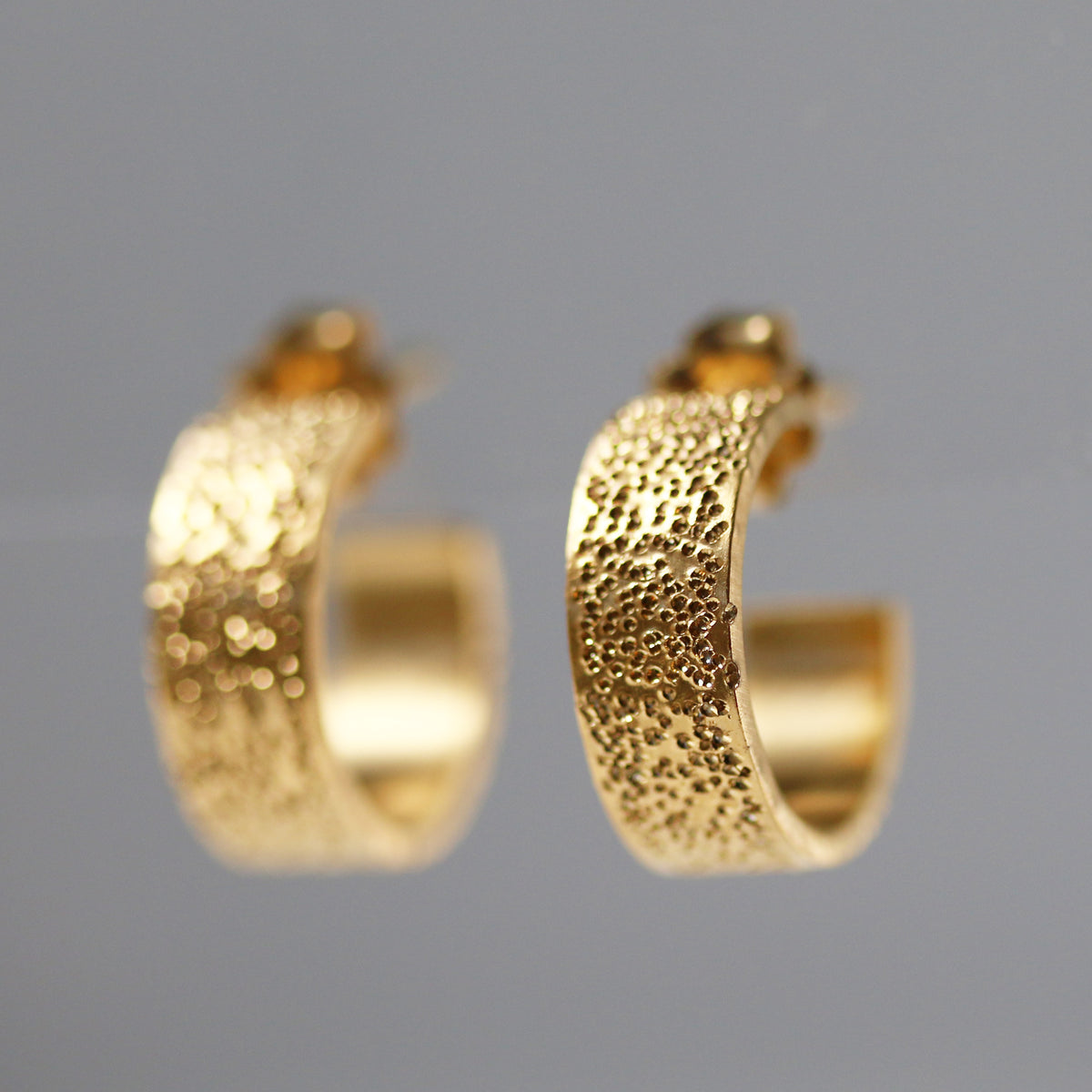 Diamond-dusted gold vermeil huggie hoop earrings, textured curved design
