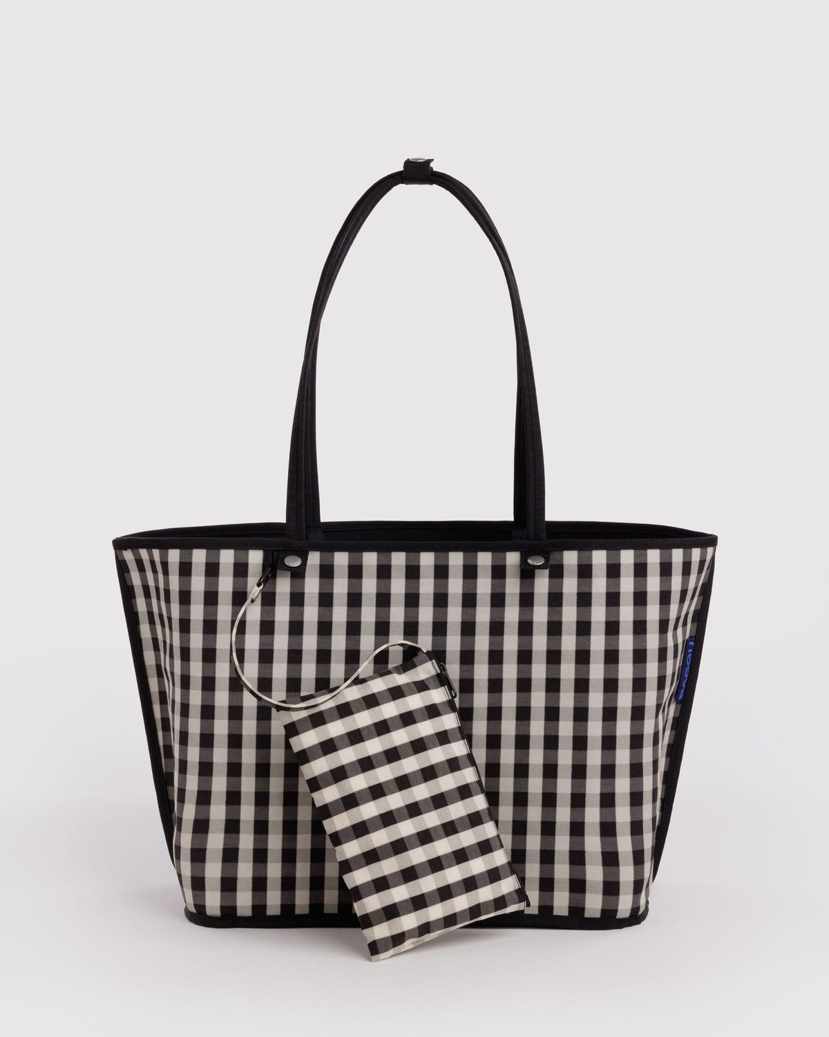 Large nylon reversible tote with black-and-white gingham exterior and striped pouch
