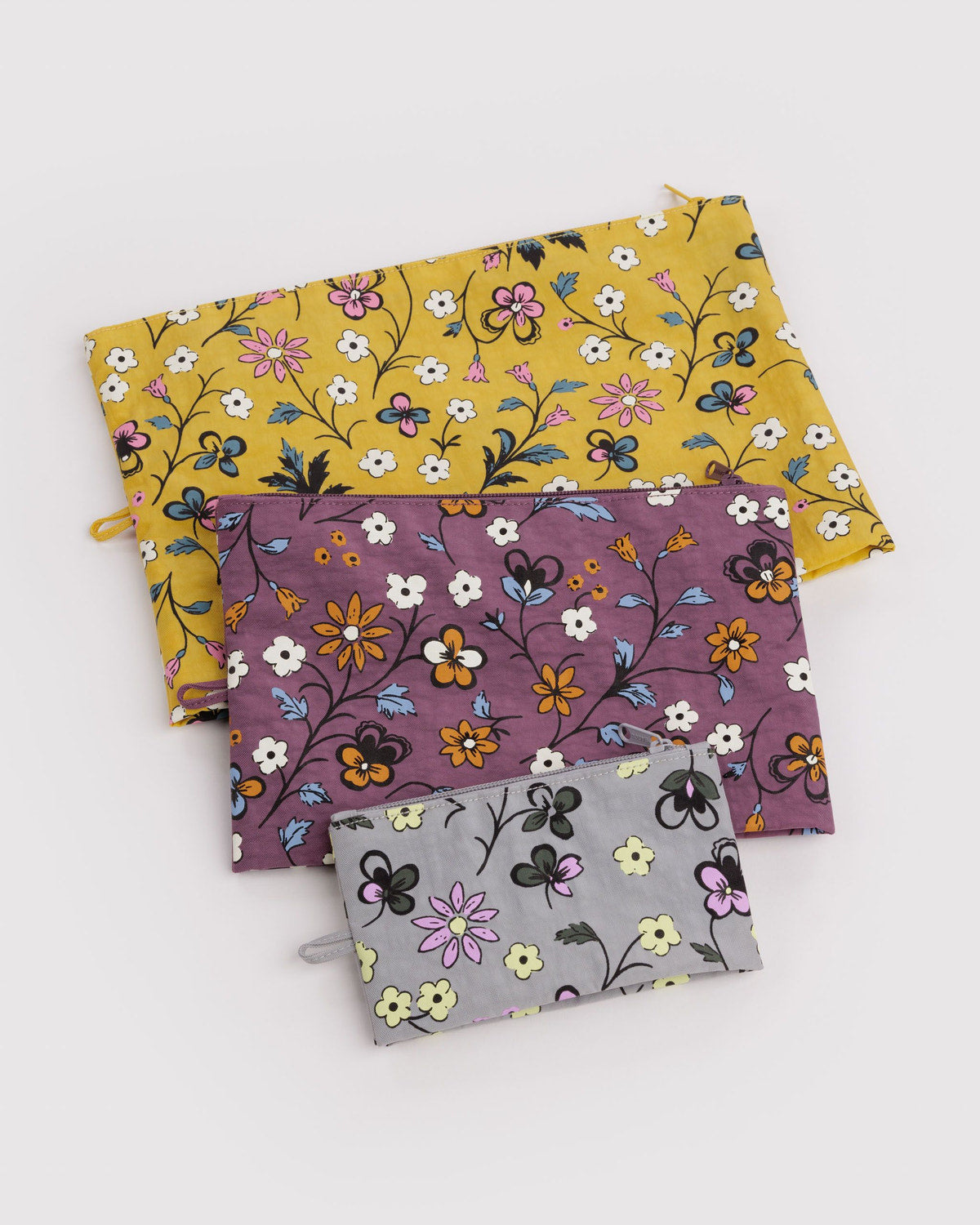 Go pouch set of three fabric zip pouches with floral prints in yellow, purple, and gray