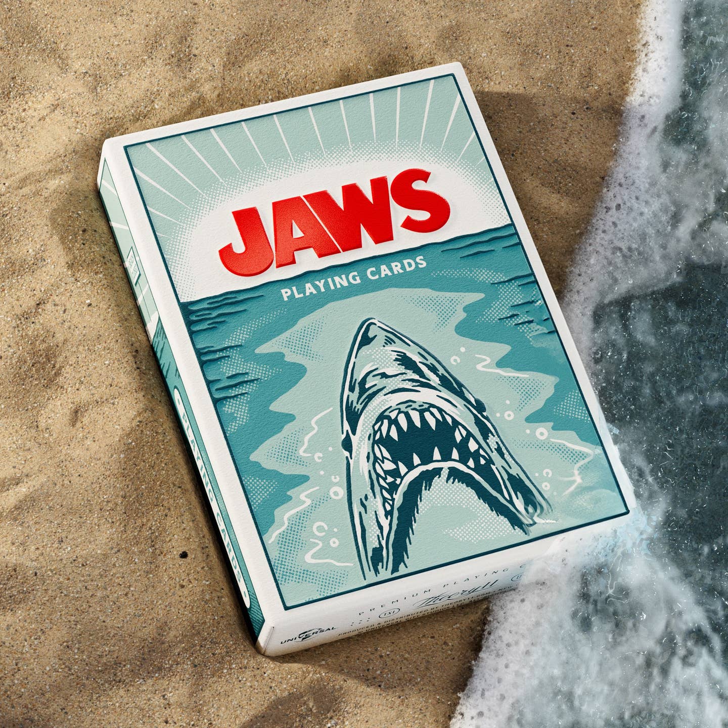 Jaws playing cards deck box with teal shark artwork and bold JAWS logo