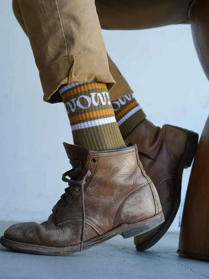 Crew socks in olive with striped cuffs and WOW! lettering