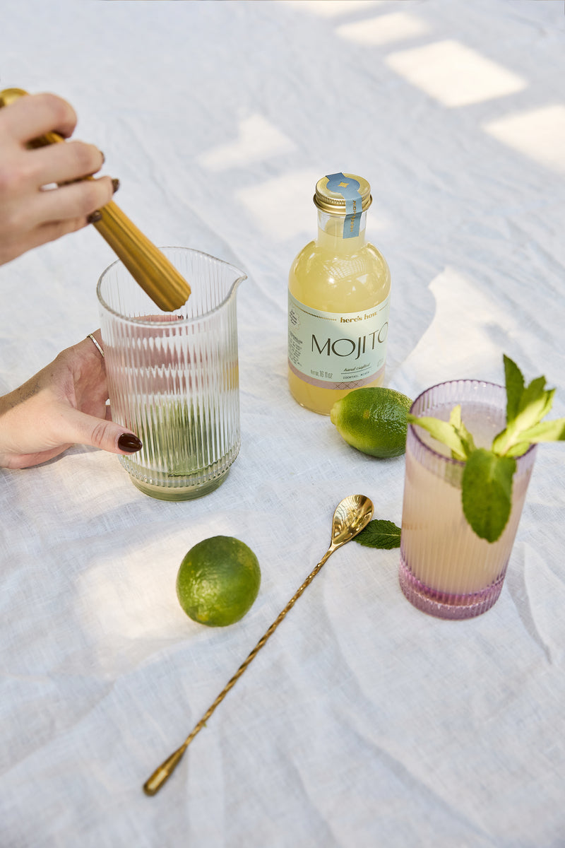 Lilac ribbed highball glass with vertical stripes, holding a drink for entertaining