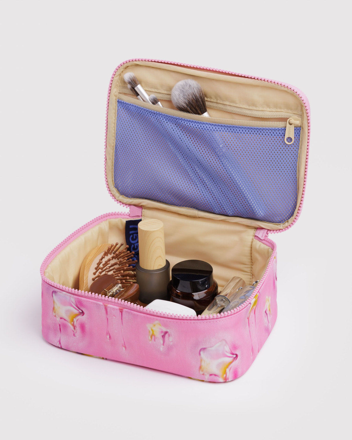 Small cosmetic case, open pink interior with blue mesh pocket and makeup brushes