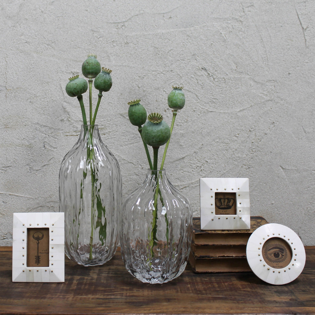 Rectangular bone photo frame with brass rivets on shelf display, cream white.