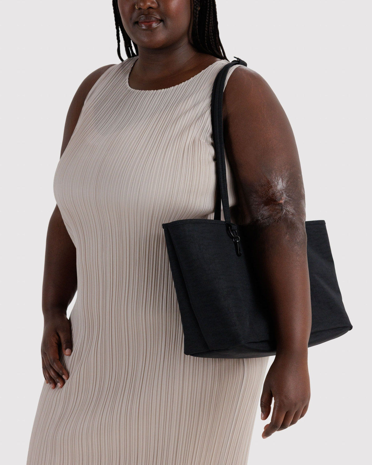 Medium nylon reversible tote with top handles and zip closure, black.