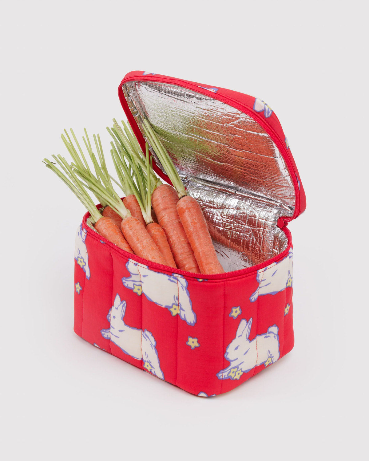 Puffy lunch bag with red bunny print, open top with carrots inside