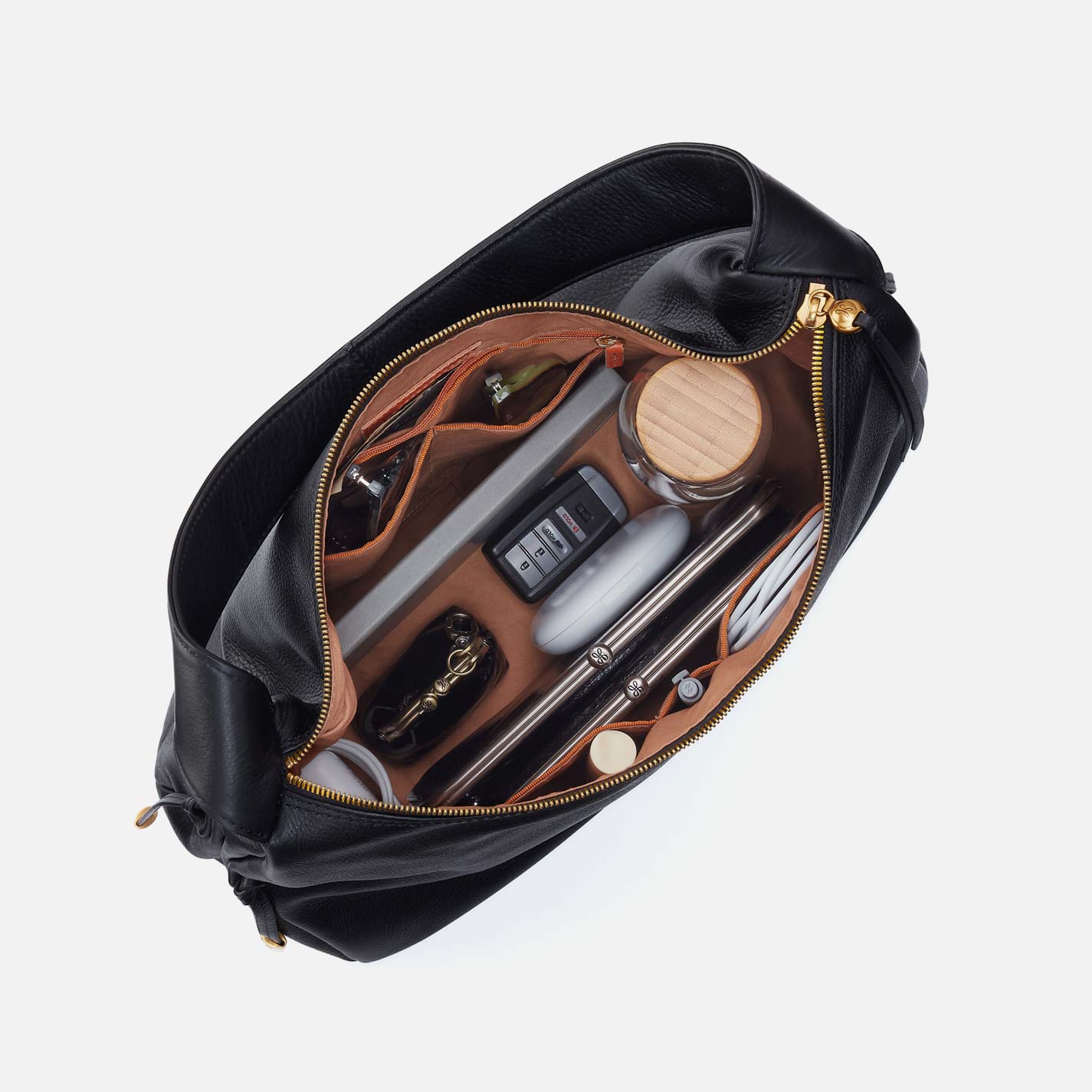 Black hobo bag open view showing interior zip pocket and assorted accessories