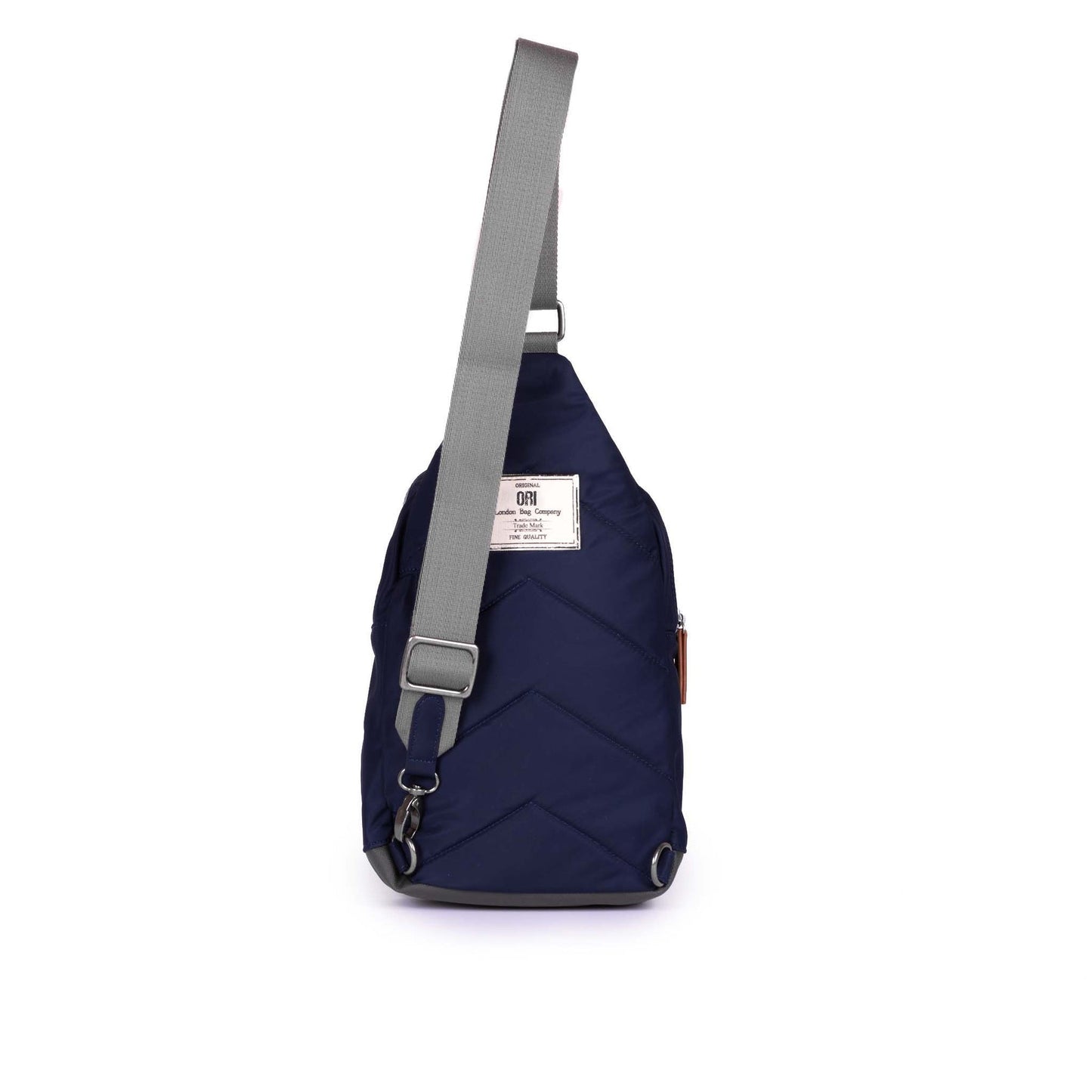 Large dark blue sling bag with adjustable strap and small rear label patch