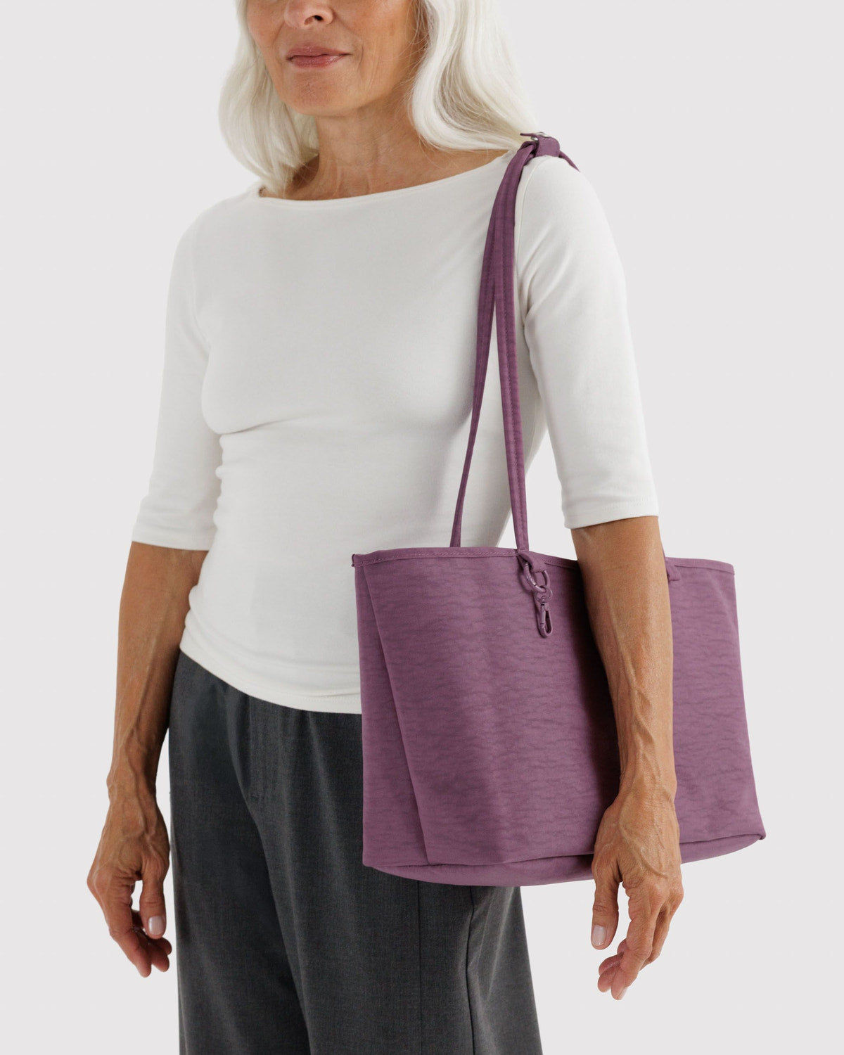 Medium reversible nylon tote with top handles and zip closure, plum.