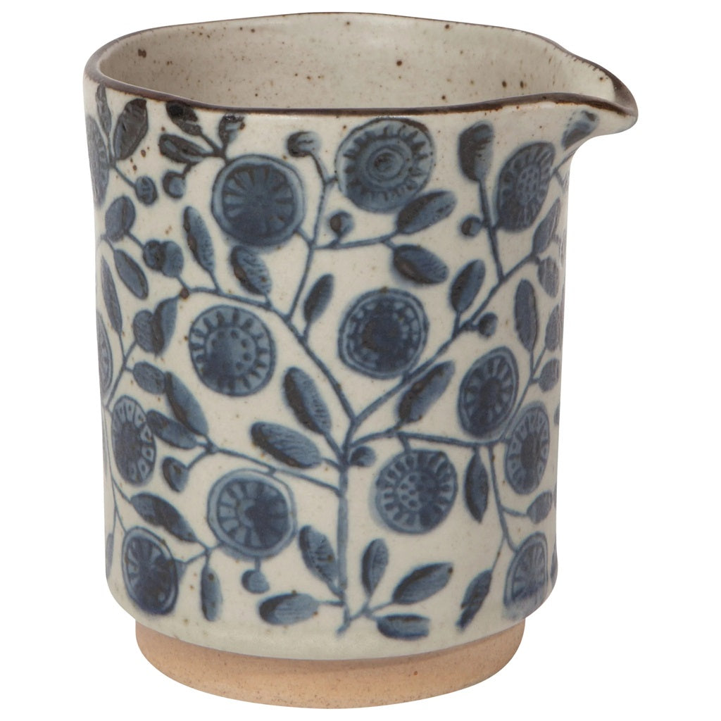 Ceramic cream jug with blue floral and circular pattern, speckled beige exterior