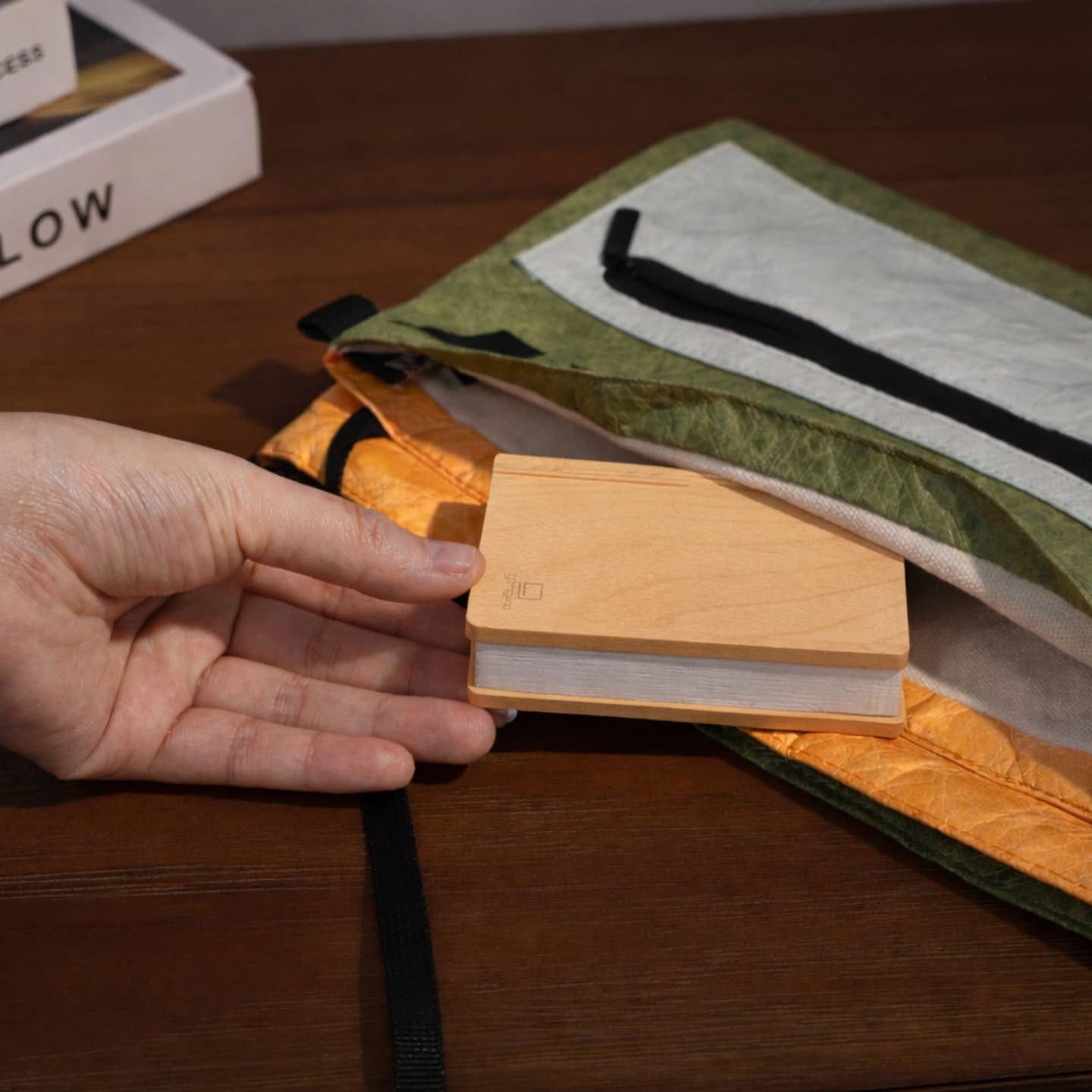 Smart book light held in hand, light wood rectangular base with hinged arm