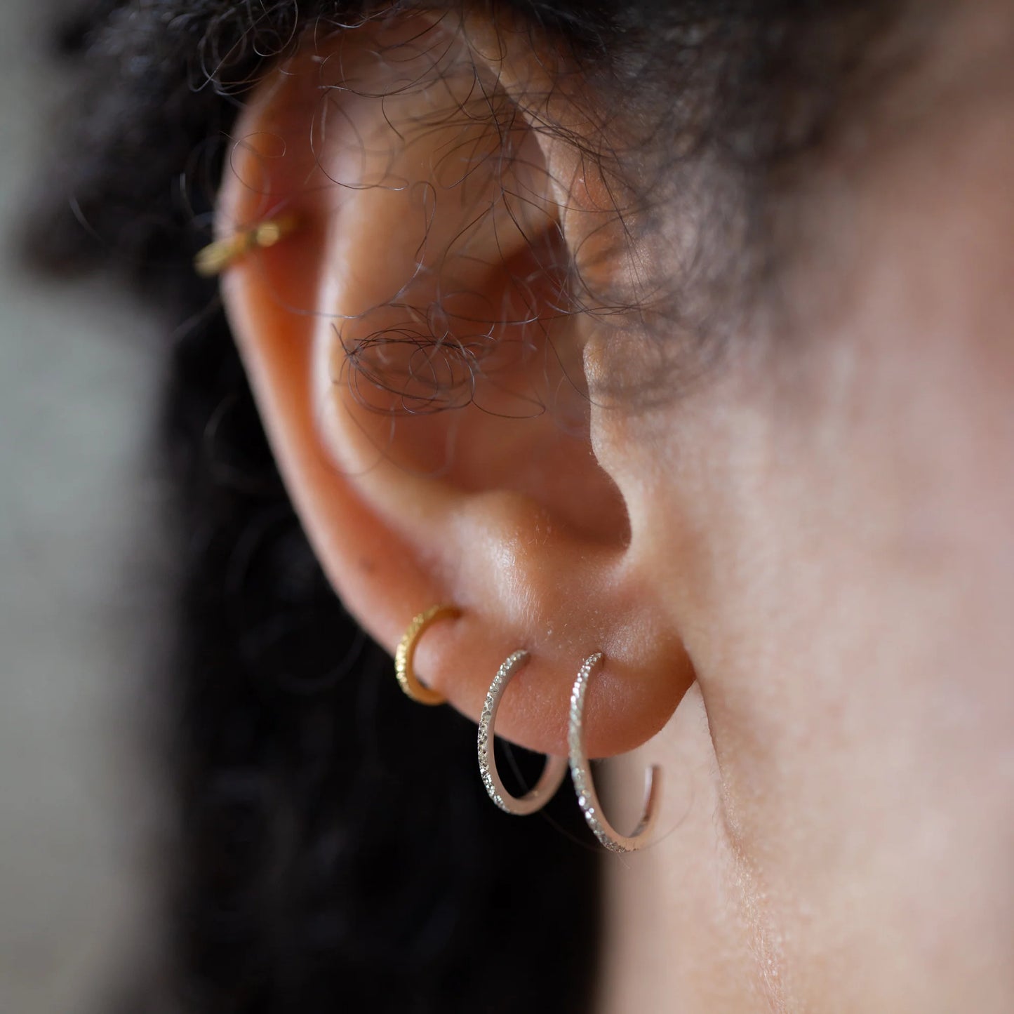 Diamond-dusted huggie hoop earrings with gold and silver-tone rings