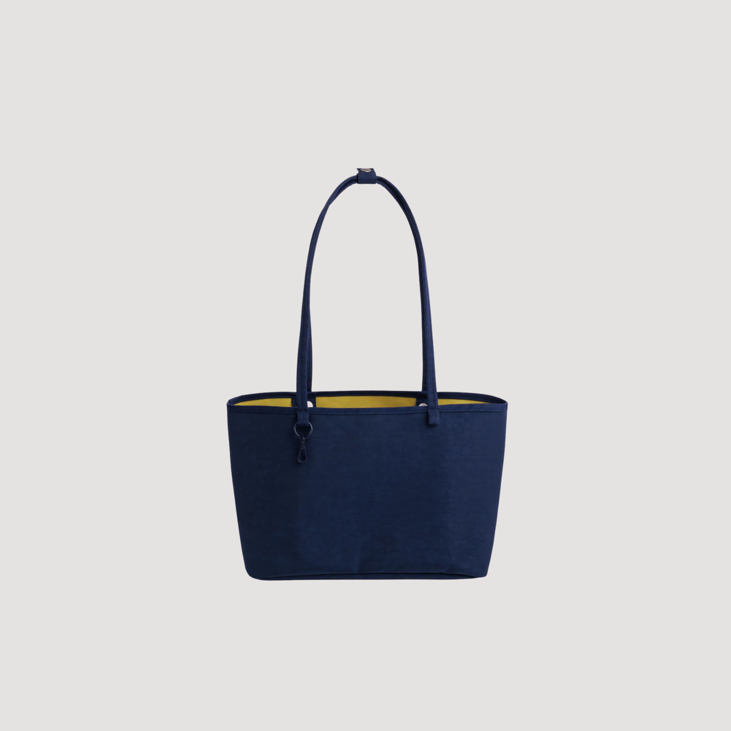 Medium reversible nylon tote with top handles and zip closure, navy blue.