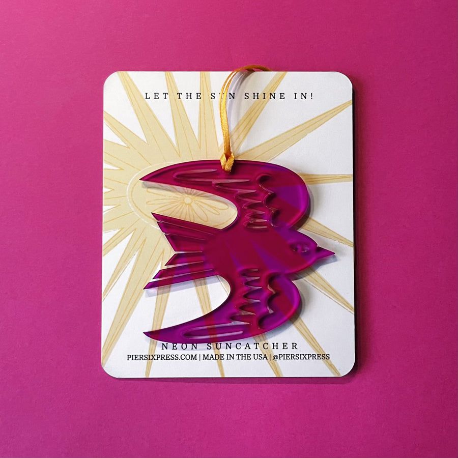 Purple acrylic swallow suncatcher with gold sunburst rays and hanging cord