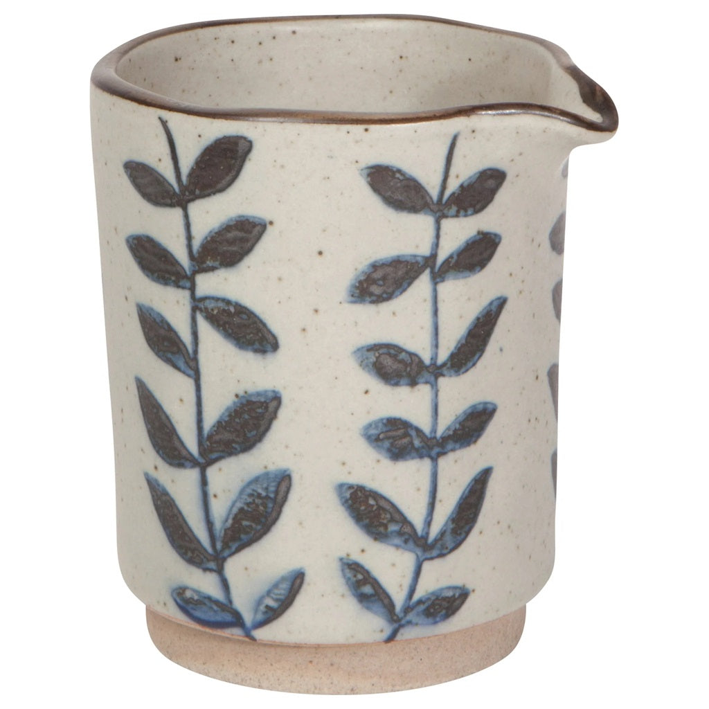 Ceramic cream jug with blue leaf and branch pattern, speckled beige exterior